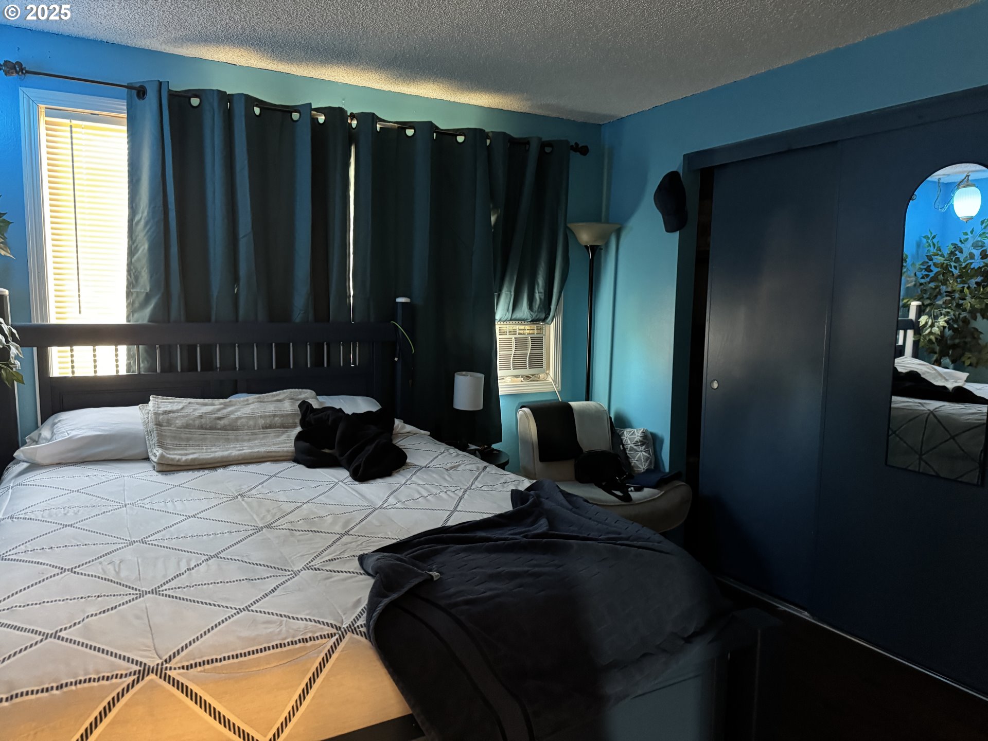 3398 Southwest 125th Avenue Beaverton, OR 97005 - Photo 20 of 25 a bed sitting in a bedroom next to a window and potted plant