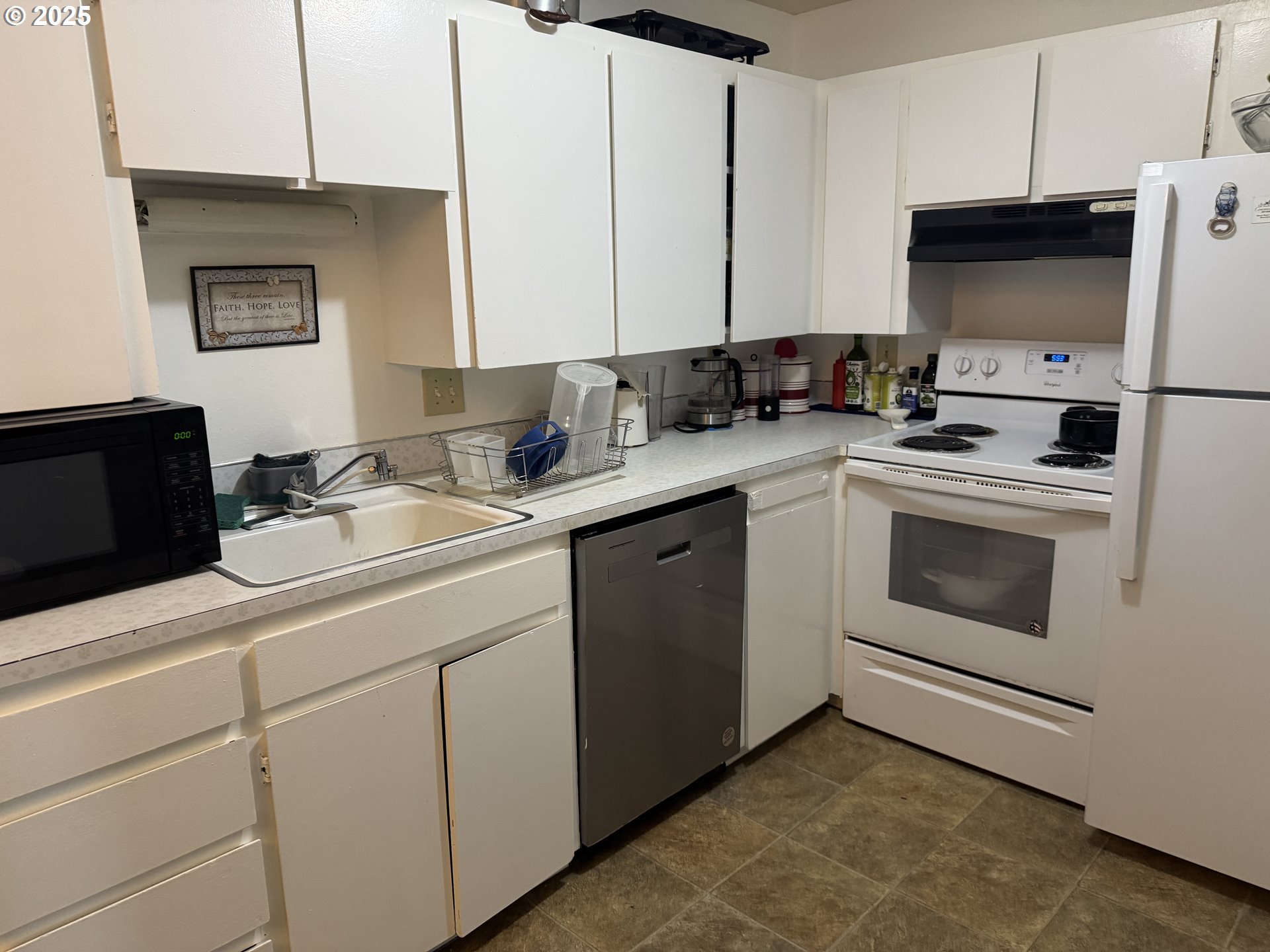 3398 Southwest 125th Avenue Beaverton, OR 97005 - Photo 23 of 25 a kitchen with a sink stove and microwave
