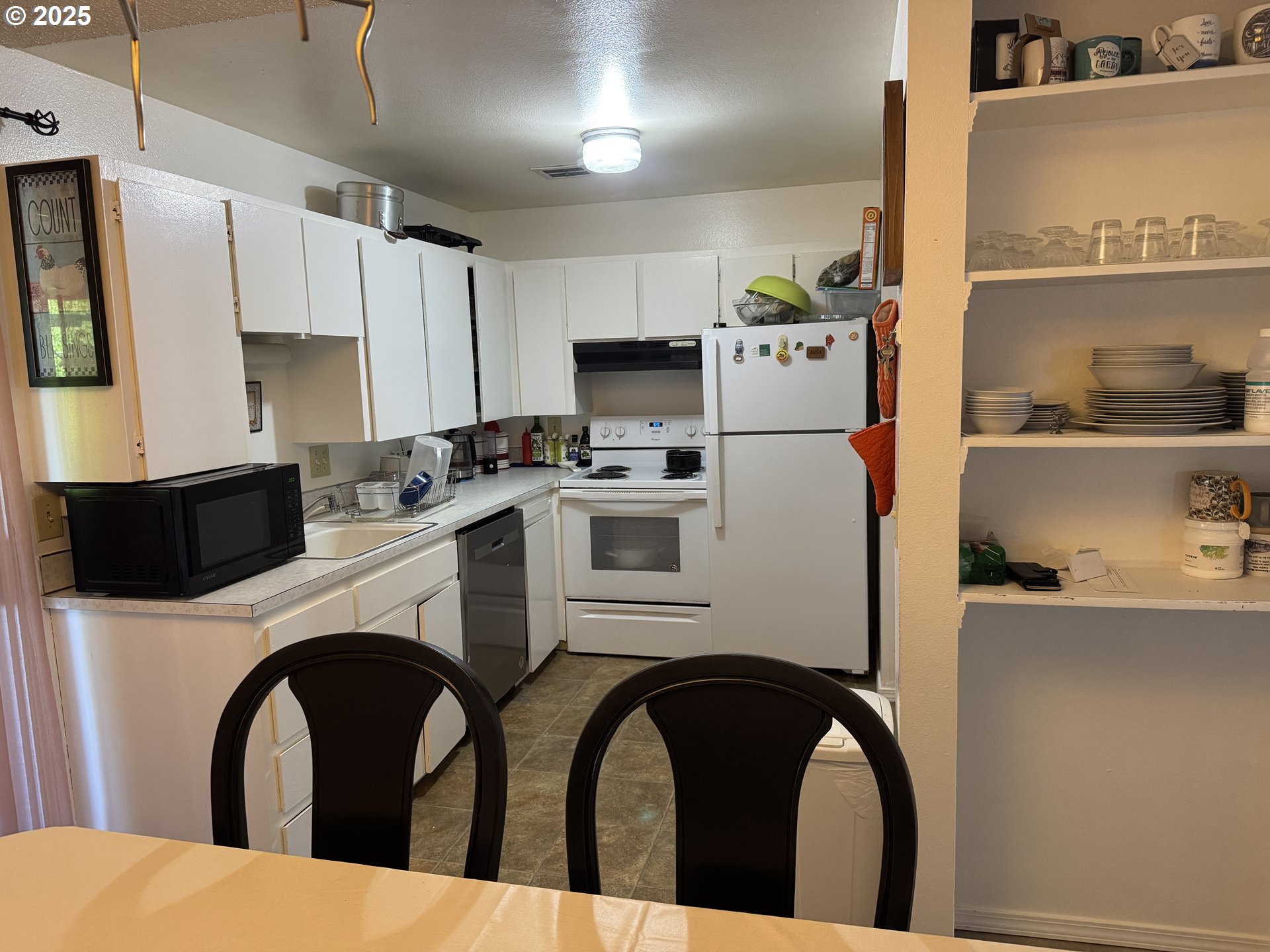 3398 Southwest 125th Avenue Beaverton, OR 97005 - Photo 9 of 25 a kitchen with stainless steel appliances a refrigerator a stove a sink a oven and cabinets