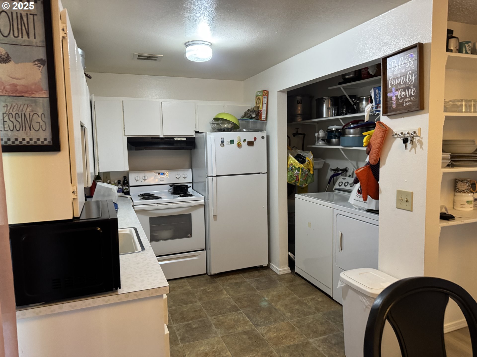 3398 Southwest 125th Avenue Beaverton, OR 97005 - Photo 10 of 25 a kitchen with stainless steel appliances a refrigerator stove and white cabinets