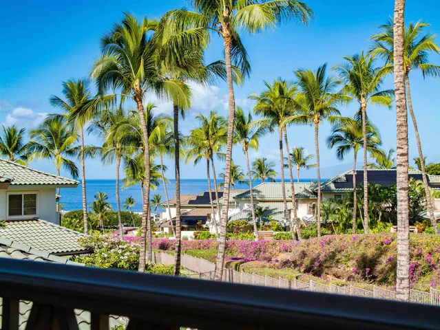 a view of a balcony with palm trees