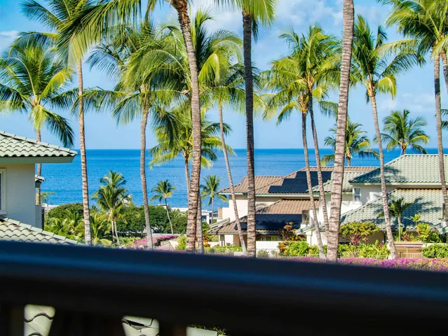 a view of ocean with a building in the background