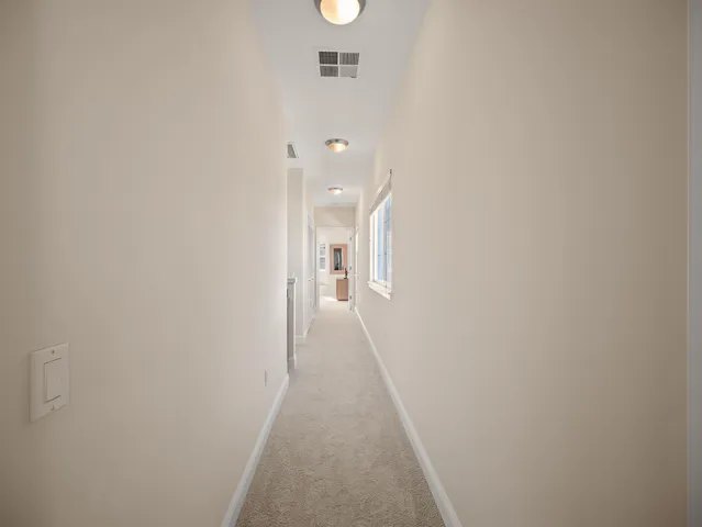 a bedroom with bed couch and window