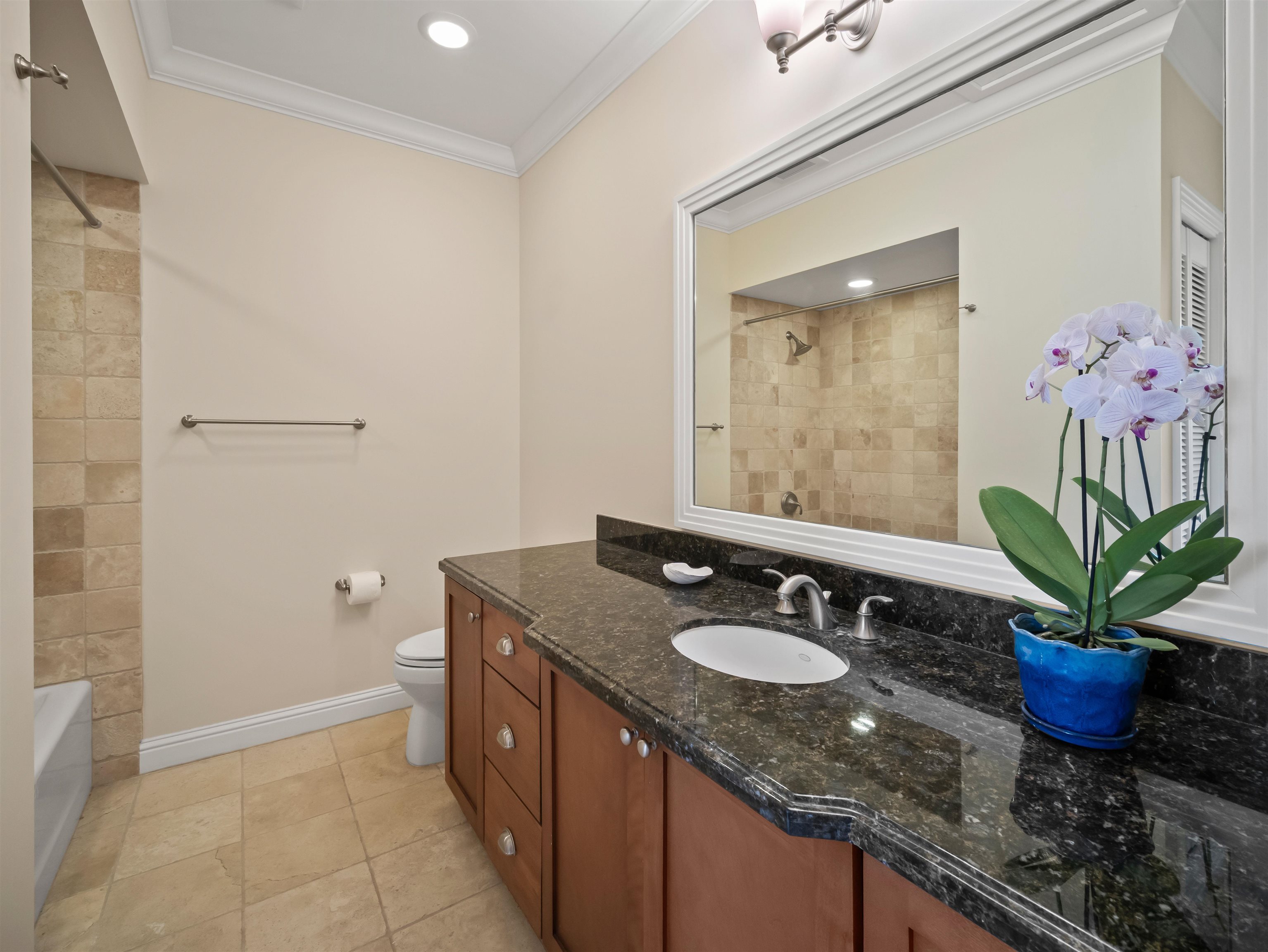 28 Kai La Place, Unit 19A Kihei, HI 96753 - Photo 30 of 49 a bathroom with a granite countertop sink a mirror and a shower