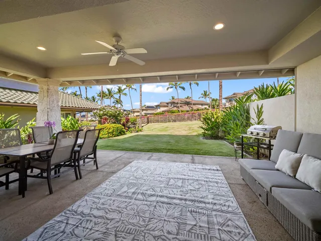 a view of a patio with a table and chairs