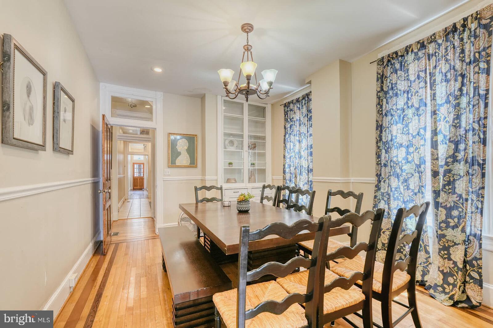 1402 Light Street Baltimore, MD 21230 - Photo 18 of 60 a living room with furniture a chandelier and a dining table
