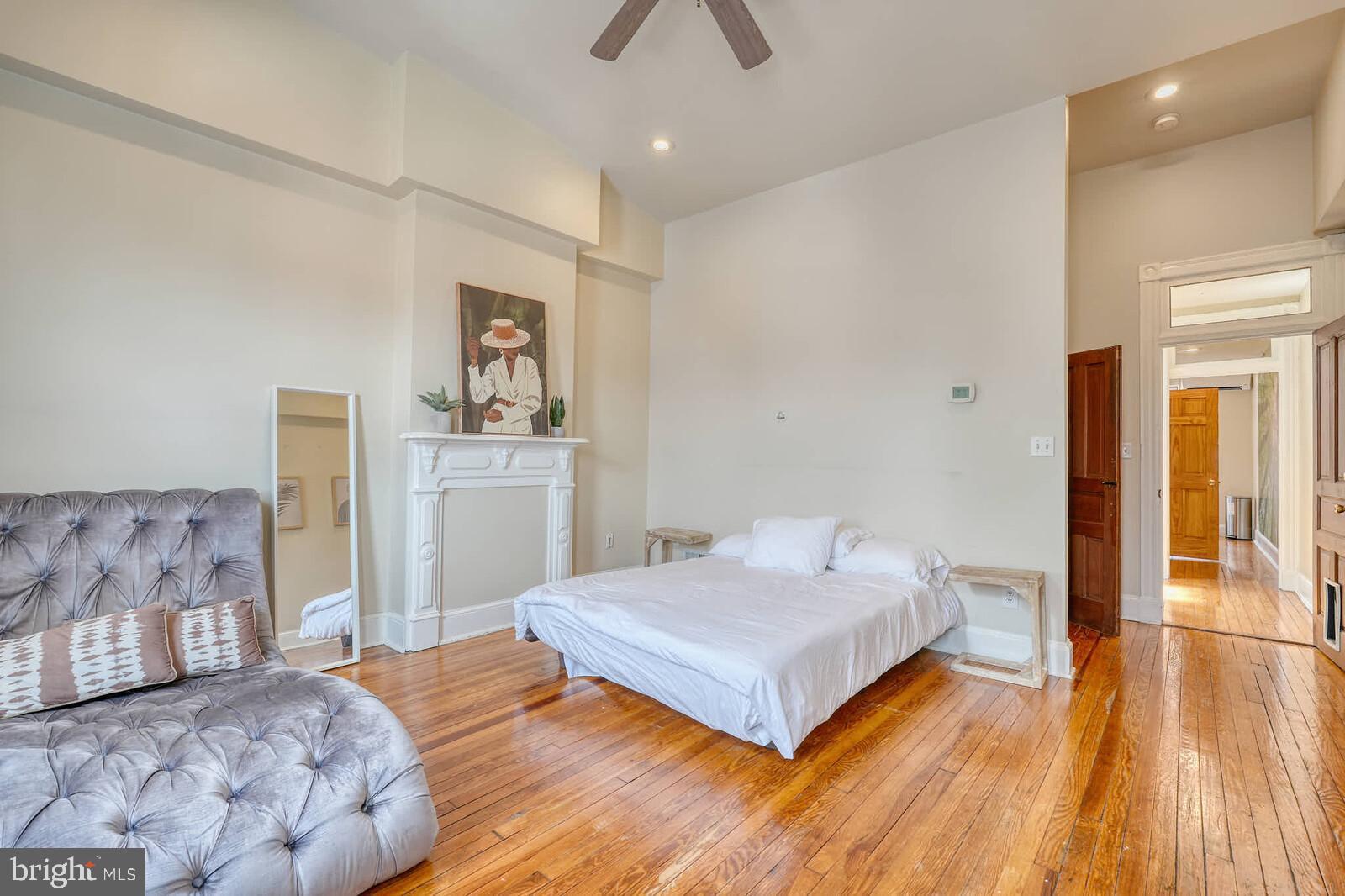 1402 Light Street Baltimore, MD 21230 - Photo 22 of 60 a spacious bedroom with a bed and a chandelier