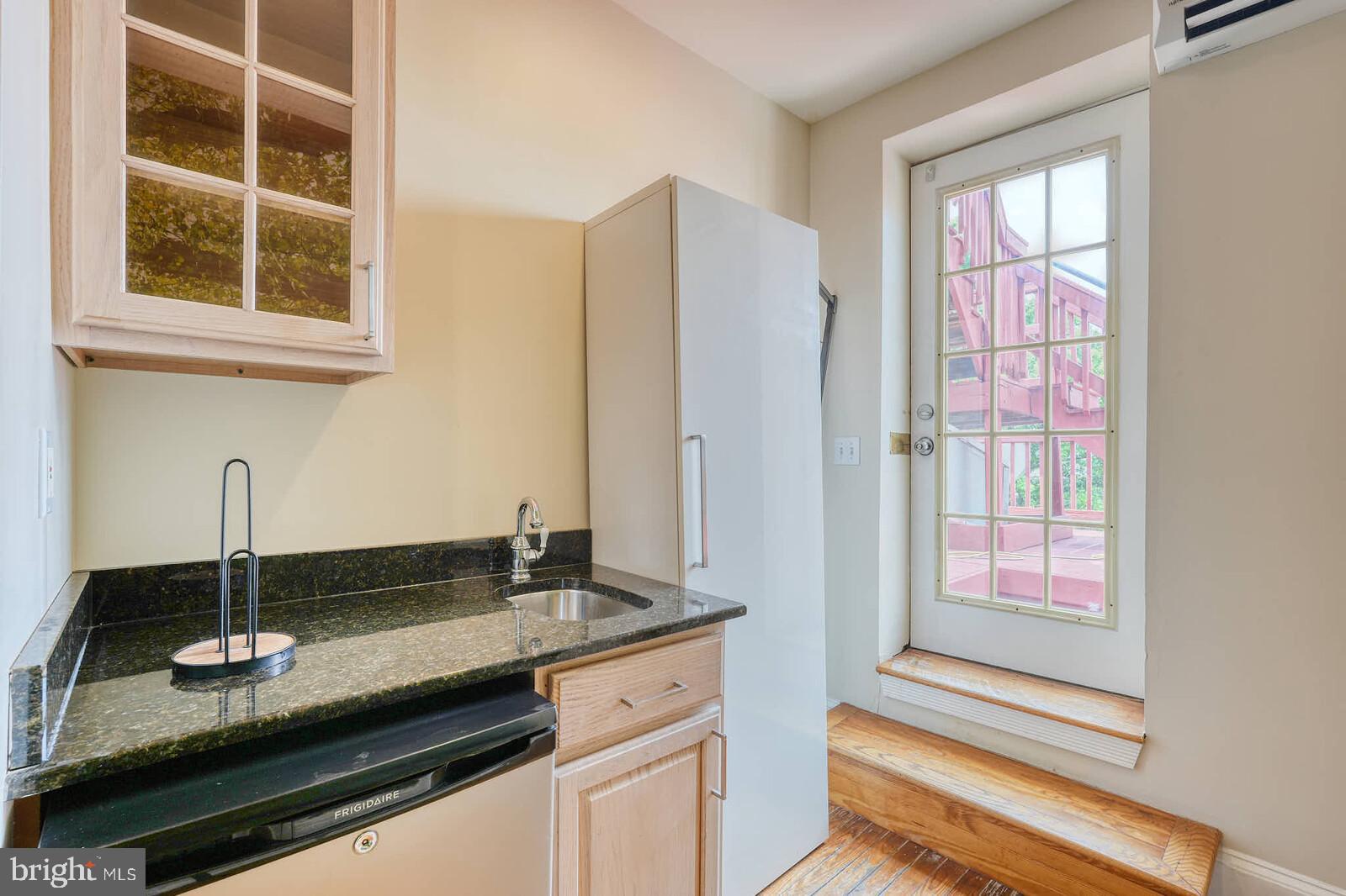 1402 Light Street Baltimore, MD 21230 - Photo 26 of 60 a kitchen with granite countertop a sink and a window
