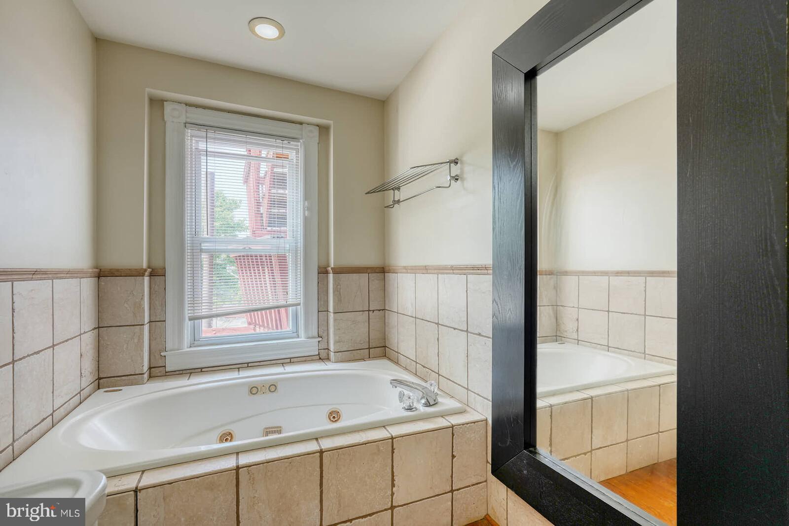 1402 Light Street Baltimore, MD 21230 - Photo 30 of 60 a bathroom with a tub and a shower