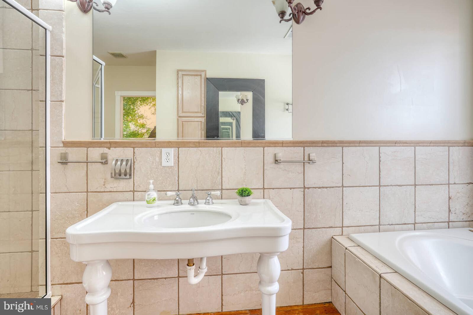 1402 Light Street Baltimore, MD 21230 - Photo 31 of 60 a bathroom with a sink and a mirror