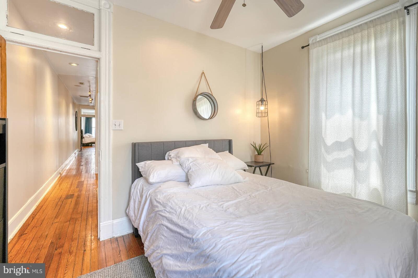 1402 Light Street Baltimore, MD 21230 - Photo 34 of 60 a bedroom with a bed and wooden floor