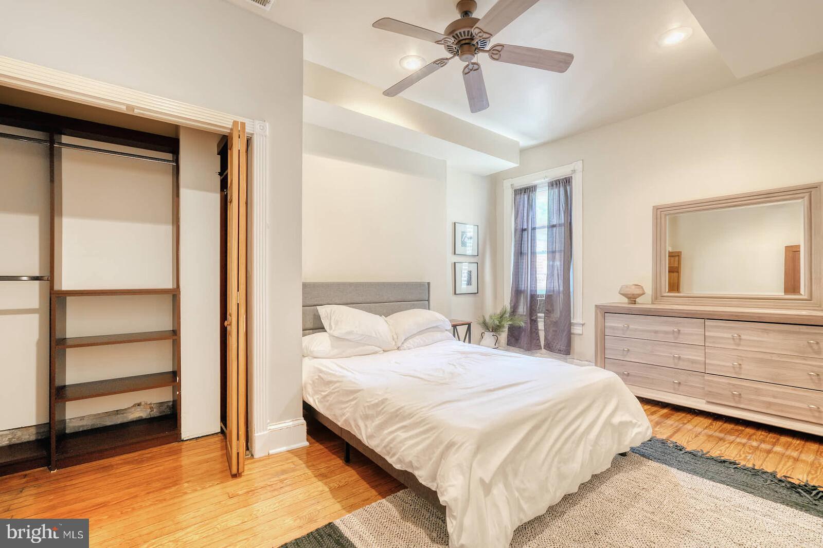 1402 Light Street Baltimore, MD 21230 - Photo 35 of 60 a bedroom with a bed and a chandelier