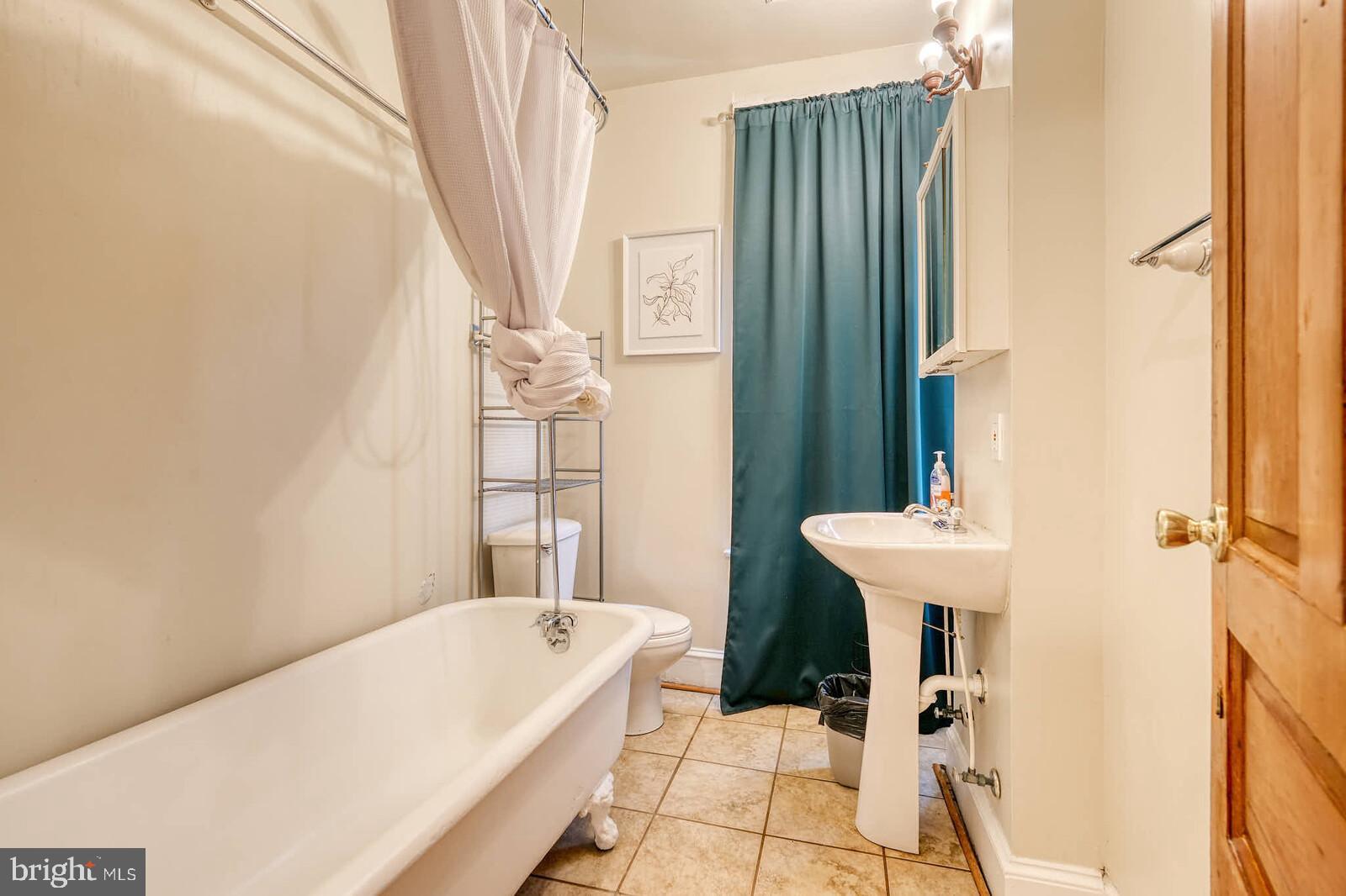 1402 Light Street Baltimore, MD 21230 - Photo 36 of 60 a bathroom with a sink a bath tub and a shower