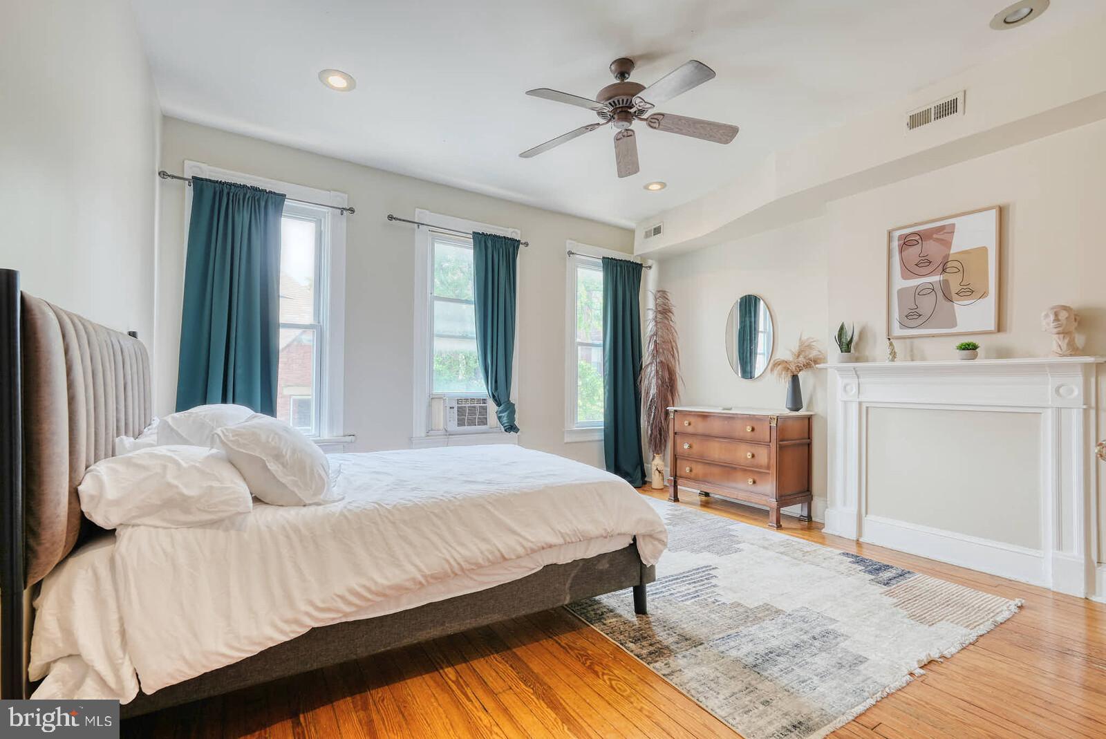 1402 Light Street Baltimore, MD 21230 - Photo 38 of 60 a bedroom with a bed a chandelier and mirror