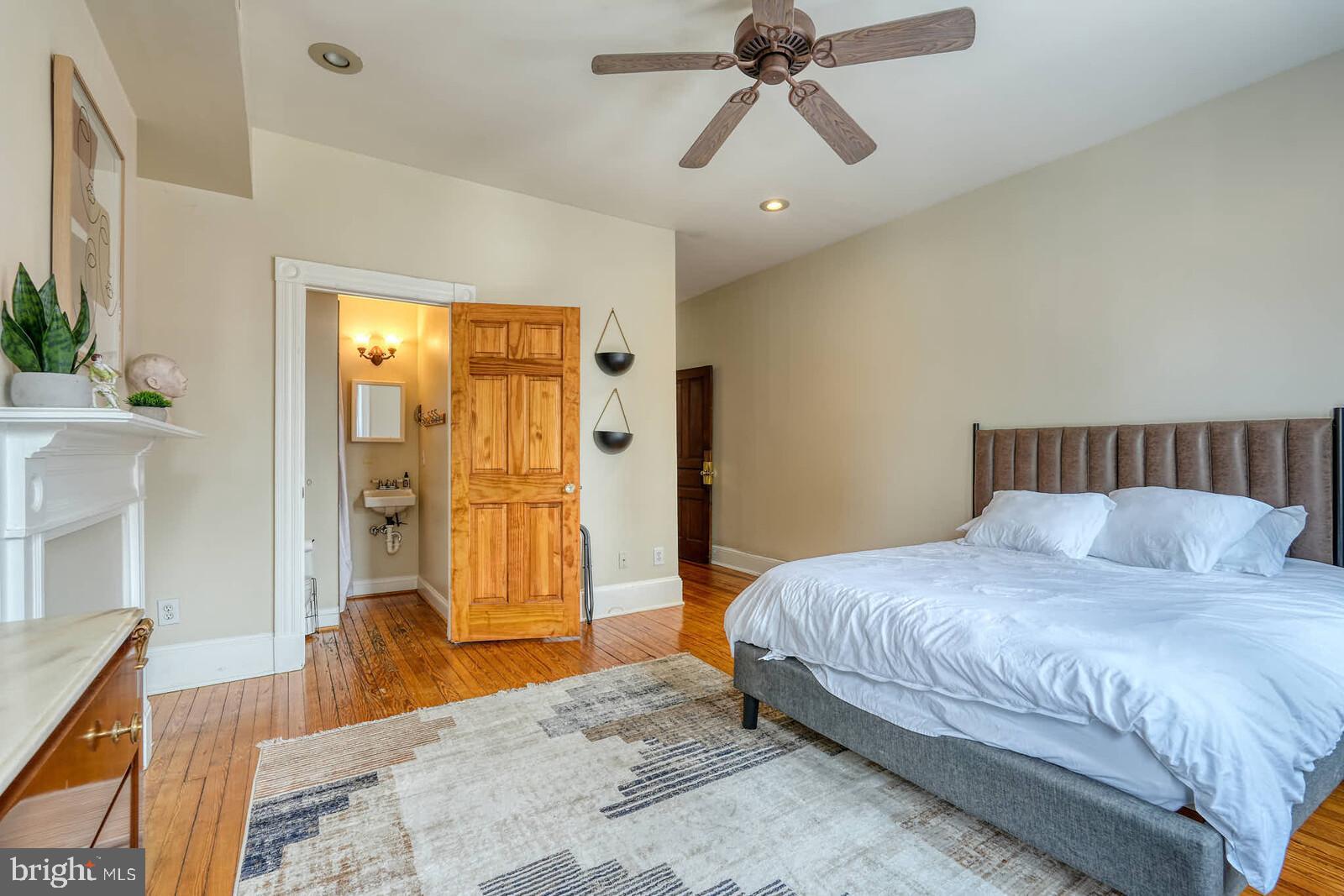 1402 Light Street Baltimore, MD 21230 - Photo 39 of 60 a bedroom with a bed and a chandelier