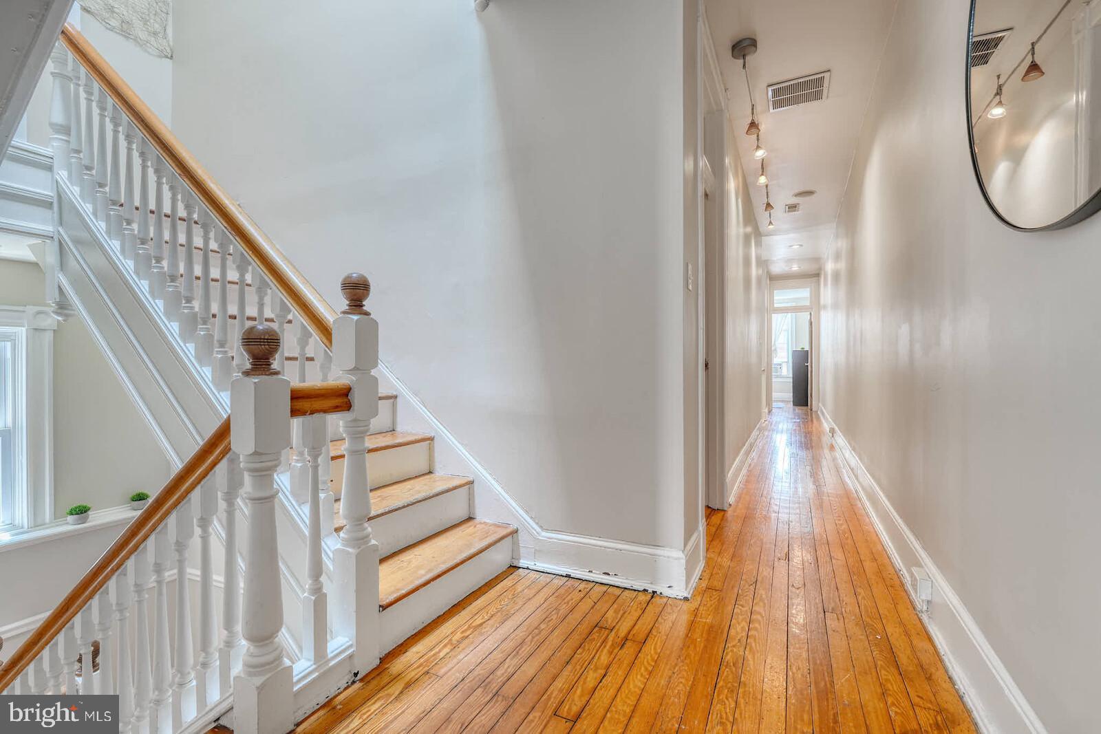 1402 Light Street Baltimore, MD 21230 - Photo 42 of 60 a view of a hallway with wooden floor and staircase
