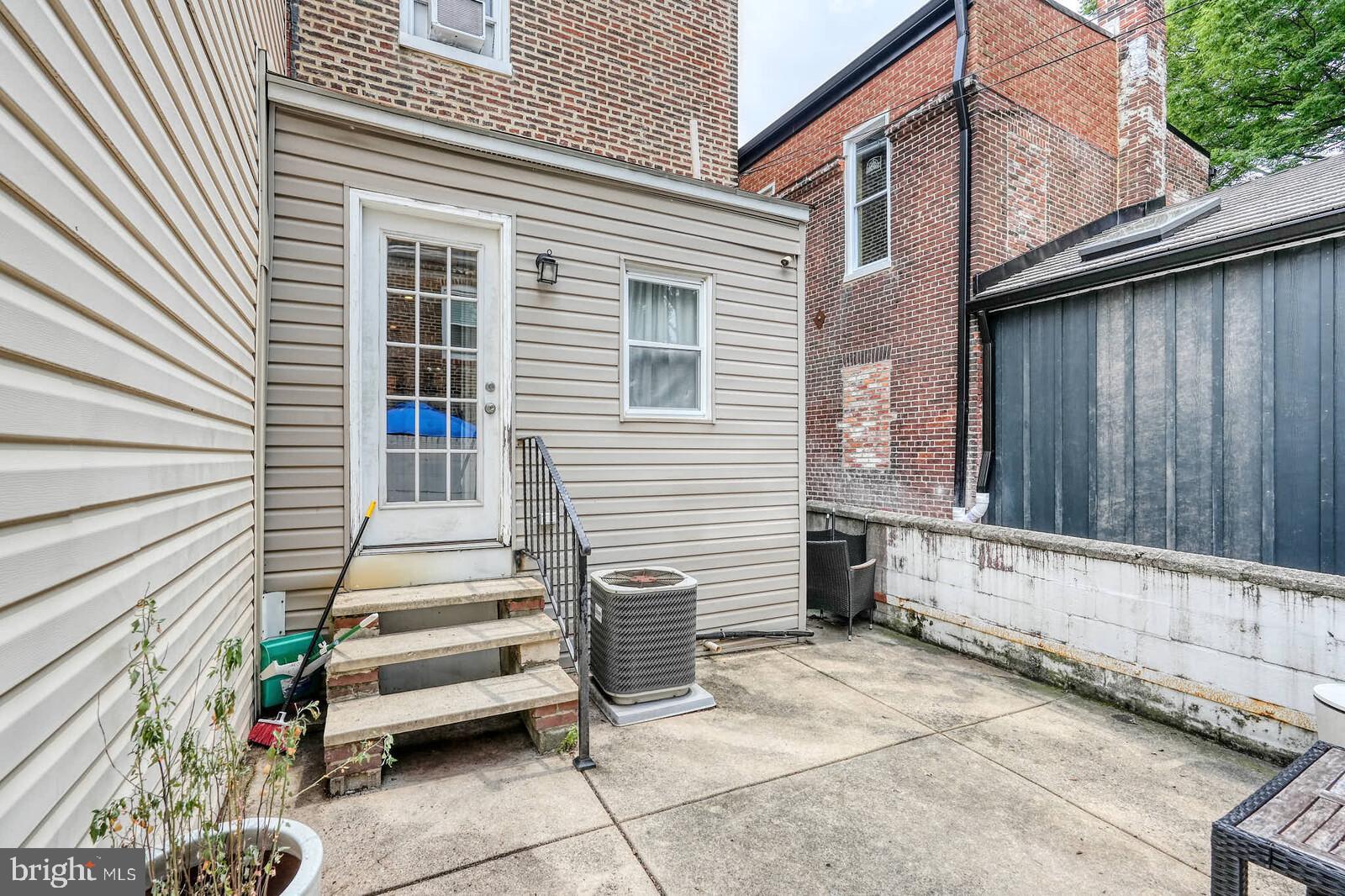 1402 Light Street Baltimore, MD 21230 - Photo 52 of 60 a view of a house with a barbeque and wooden stairs