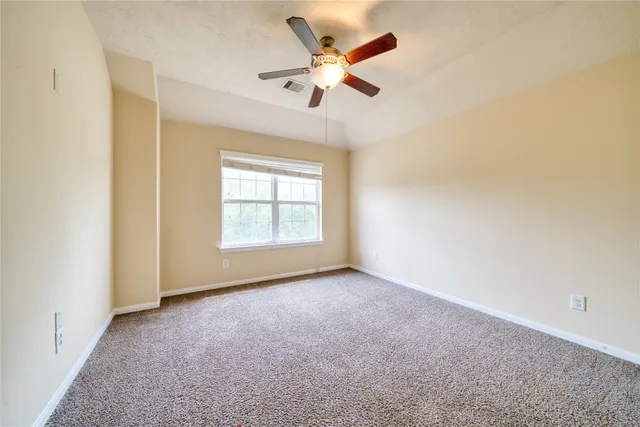 a living room with furniture a flat screen tv and a window