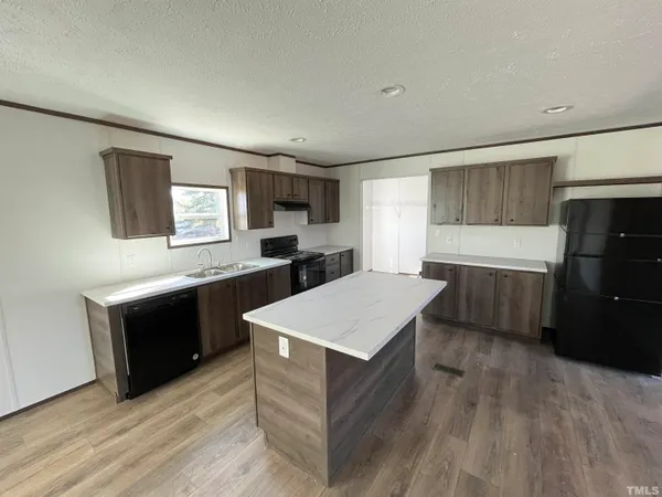 a kitchen with a refrigerator and a sink