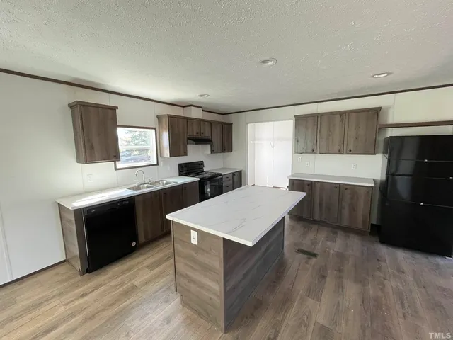 a kitchen with a refrigerator and a sink