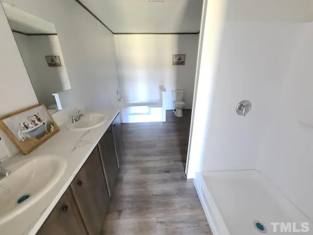 a bathroom with a sink a mirror and a bathtub