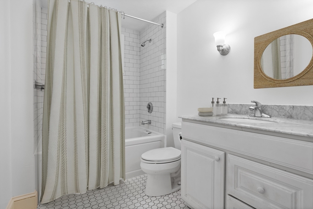 94 Codman Road Lincoln, MA 01773 - Photo 11 of 22 a bathroom with a granite countertop toilet a sink and a mirror