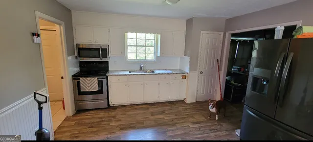 a kitchen with a refrigerator stove and a sink