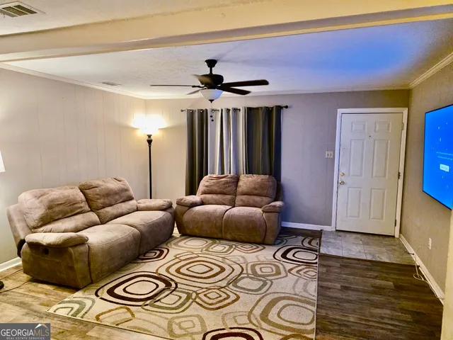 a bedroom with furniture and a rug