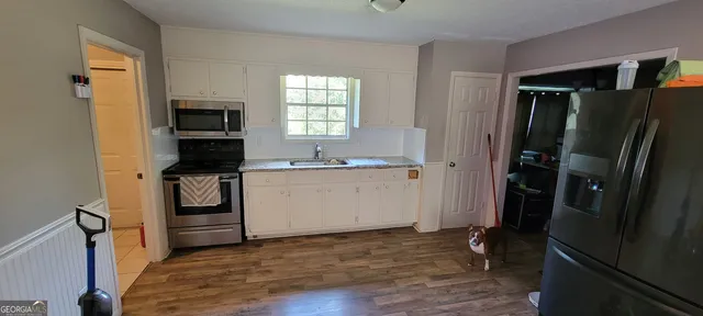 a kitchen with a refrigerator stove and a sink