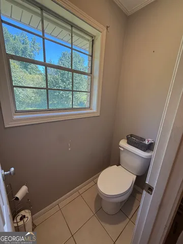a white toilet sitting next to a window