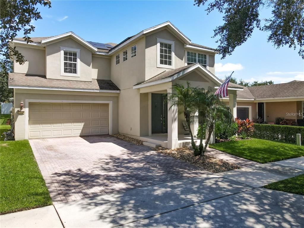 13225 Charfield Street Windermere, FL 34786 - Photo 2 of 40 a front view of a house with a yard and garage