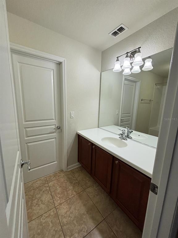 13225 Charfield Street Windermere, FL 34786 - Photo 22 of 40 a bathroom with a double vanity sink and mirror