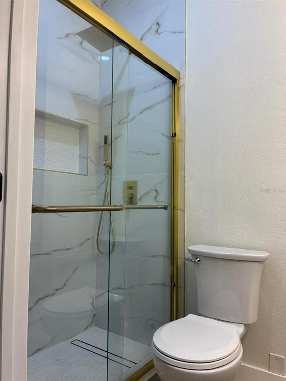 13225 Charfield Street Windermere, FL 34786 - Photo 27 of 40 a white toilet sitting next to a bathroom