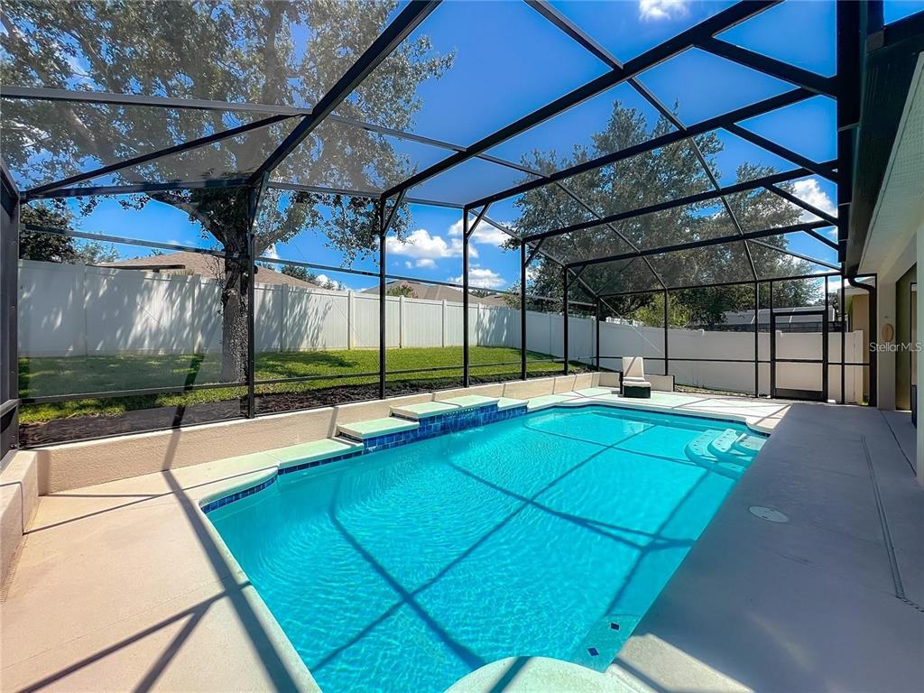 13225 Charfield Street Windermere, FL 34786 - Photo 33 of 40 a view of a backyard with a tub and wooden fence