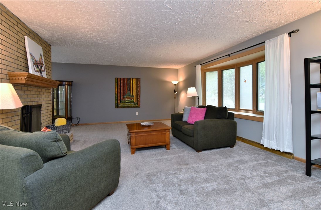 2071 Wyndham Road Akron, OH 44313 - Photo 3 of 42 Expansive 15' x 23' Living Room with 1 of 2 full brick, woodburning fireplaces, beautiful bay window, and light carpet.