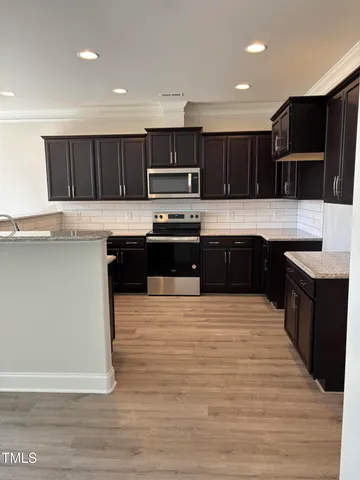 a large kitchen with wooden cabinets