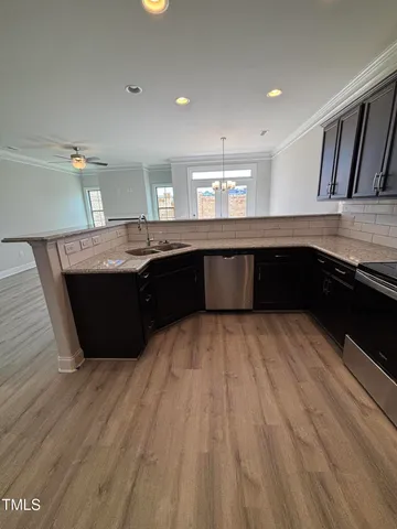 a kitchen with stainless steel appliances granite countertop a sink and cabinets