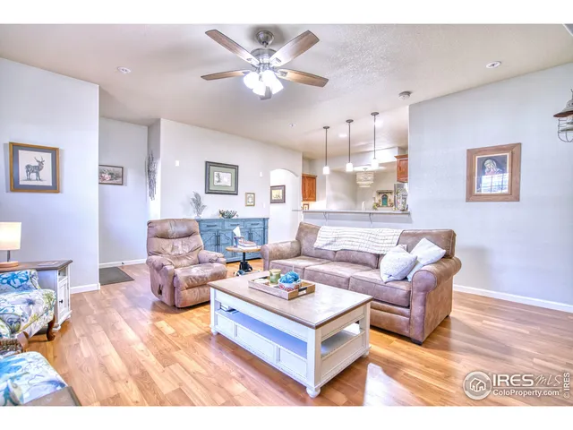 a living room with furniture a rug and a chandelier