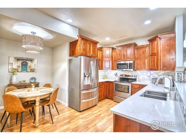 a kitchen with wooden cabinets a stove and a microwave