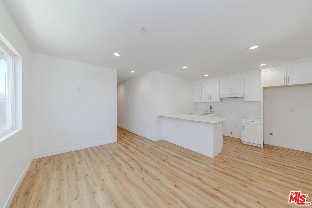 1105 East 103rd Place Los Angeles, CA 90002 - Photo 11 of 56 a view of kitchen with wooden floor