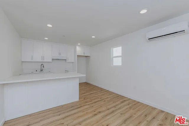 a kitchen with sink and cabinets