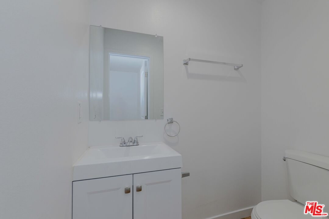 1105 East 103rd Place Los Angeles, CA 90002 - Photo 17 of 56 a bathroom with a sink and a toilet