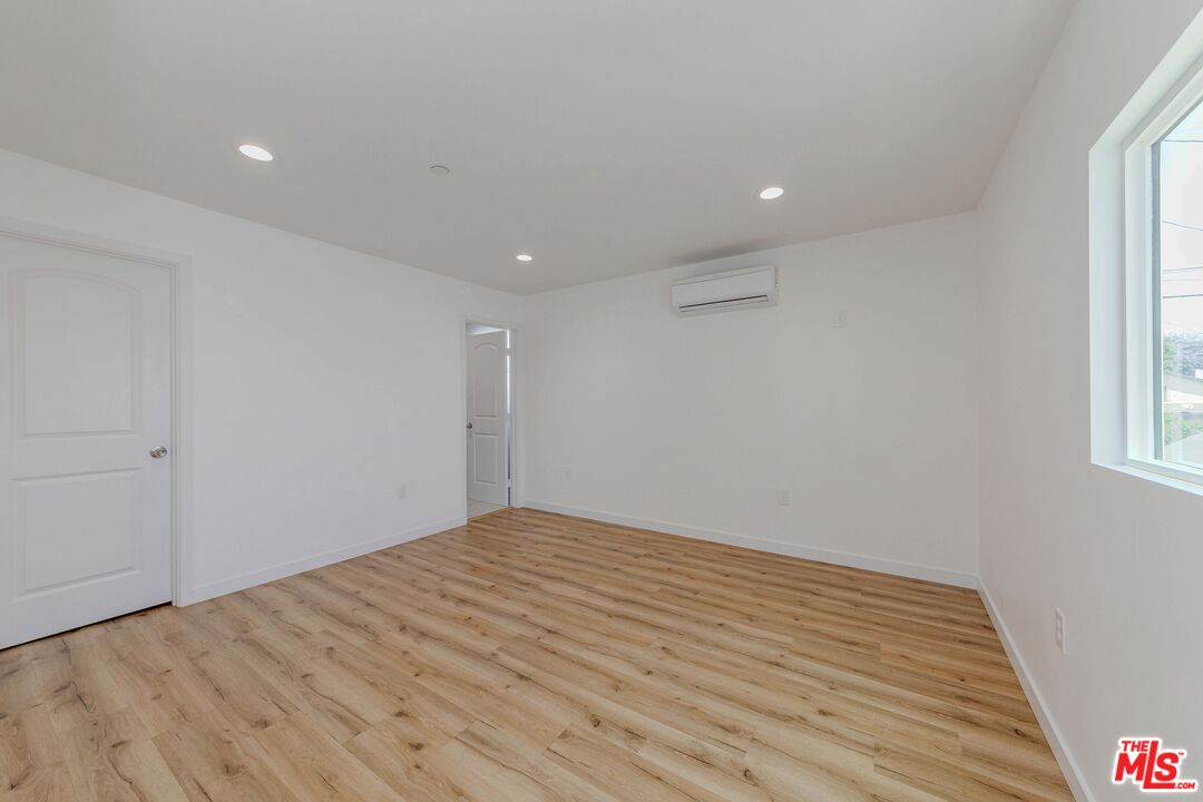 1105 East 103rd Place Los Angeles, CA 90002 - Photo 26 of 56 a view of empty room with wooden floor and fan