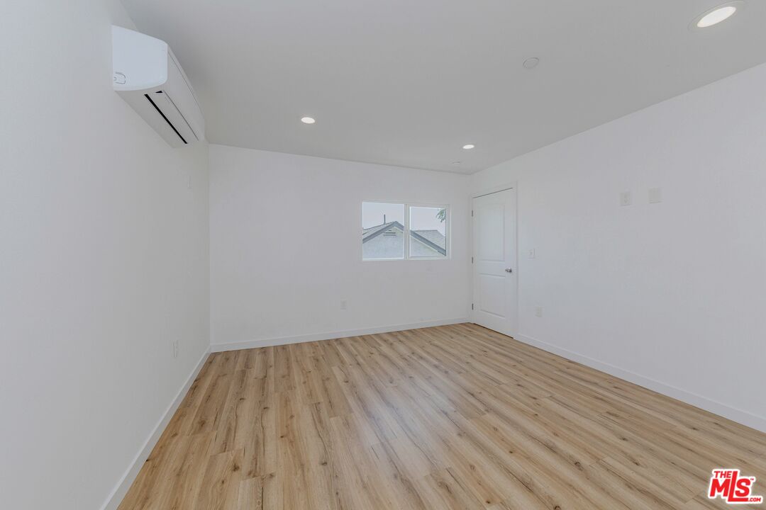 1105 East 103rd Place Los Angeles, CA 90002 - Photo 27 of 56 a view of empty room with wooden floor