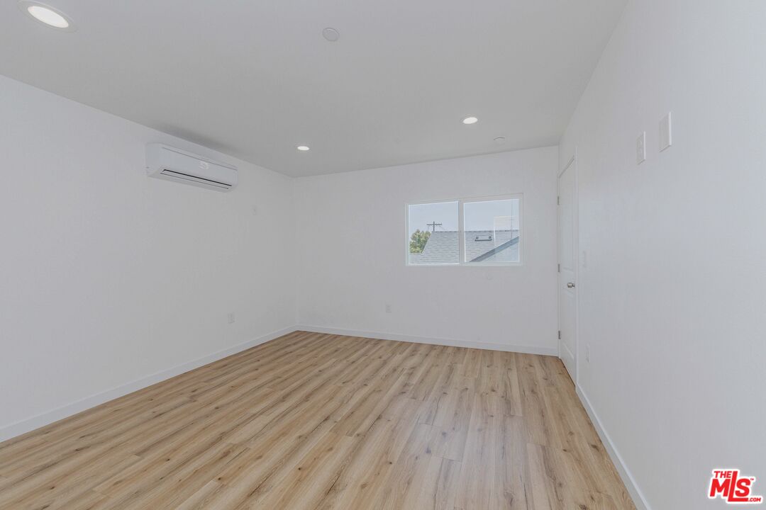 1105 East 103rd Place Los Angeles, CA 90002 - Photo 28 of 56 a view of room with wooden floor and window
