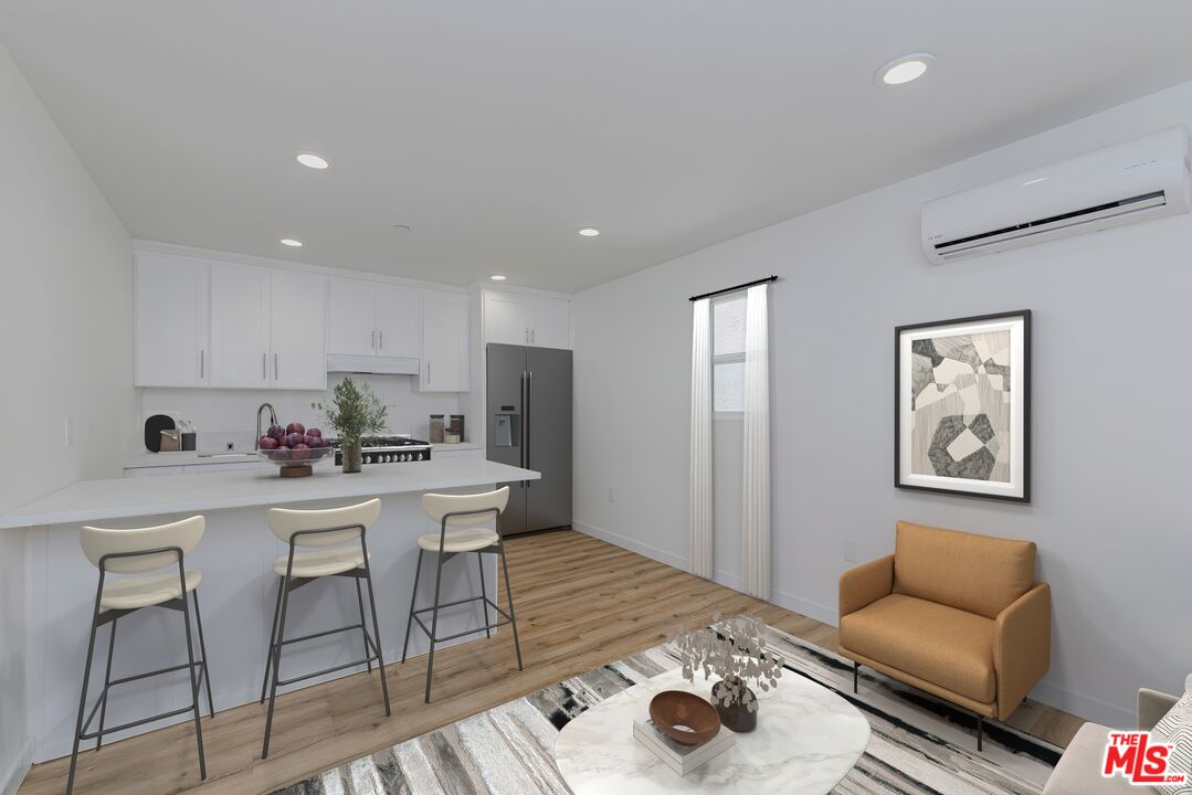 1105 East 103rd Place Los Angeles, CA 90002 - Photo 3 of 56 a living room with stainless steel appliances furniture and kitchen view