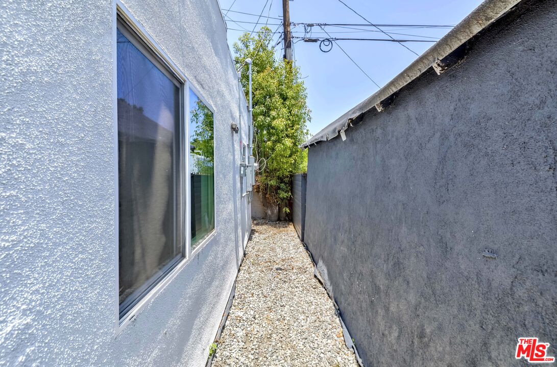 1105 East 103rd Place Los Angeles, CA 90002 - Photo 32 of 56 a view of a pathway besides a house