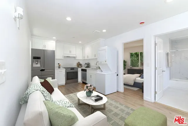 a kitchen with white cabinets and sink