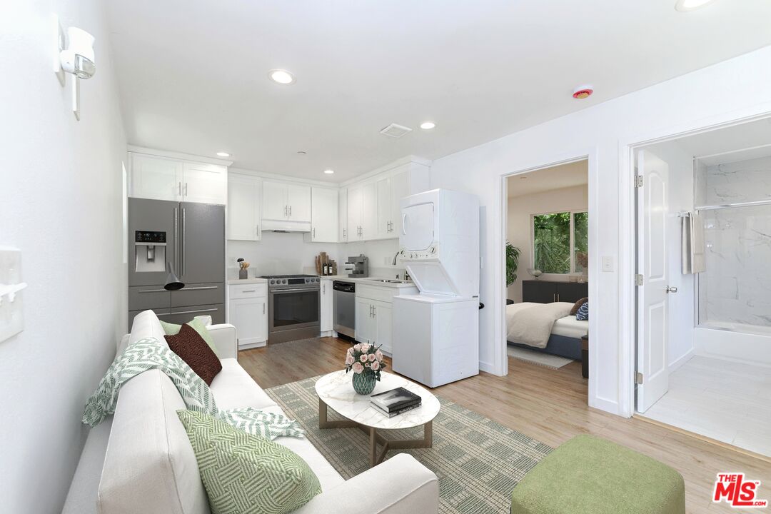 1105 East 103rd Place Los Angeles, CA 90002 - Photo 36 of 56 a living room with furniture kitchen and a table