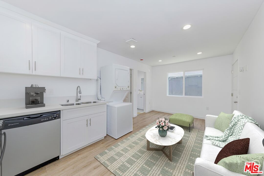 1105 East 103rd Place Los Angeles, CA 90002 - Photo 37 of 56 a living room with furniture and white wooden floor